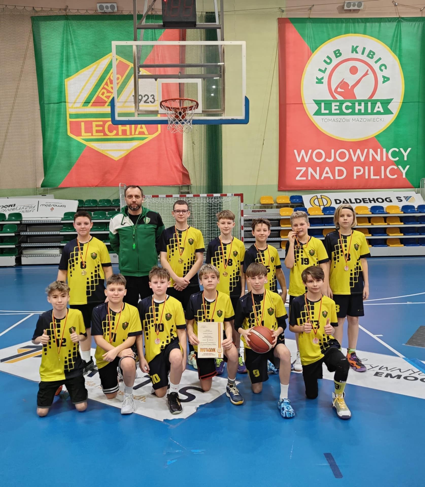 Drużyna koszykarzy z trenerem Rafałem Brzostowiczem